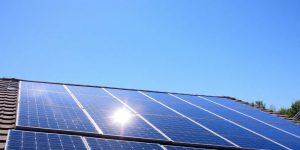 A rooftop solar panel array on a suburban home.