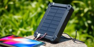 Solar power bank charging devices in natural outdoor setting.